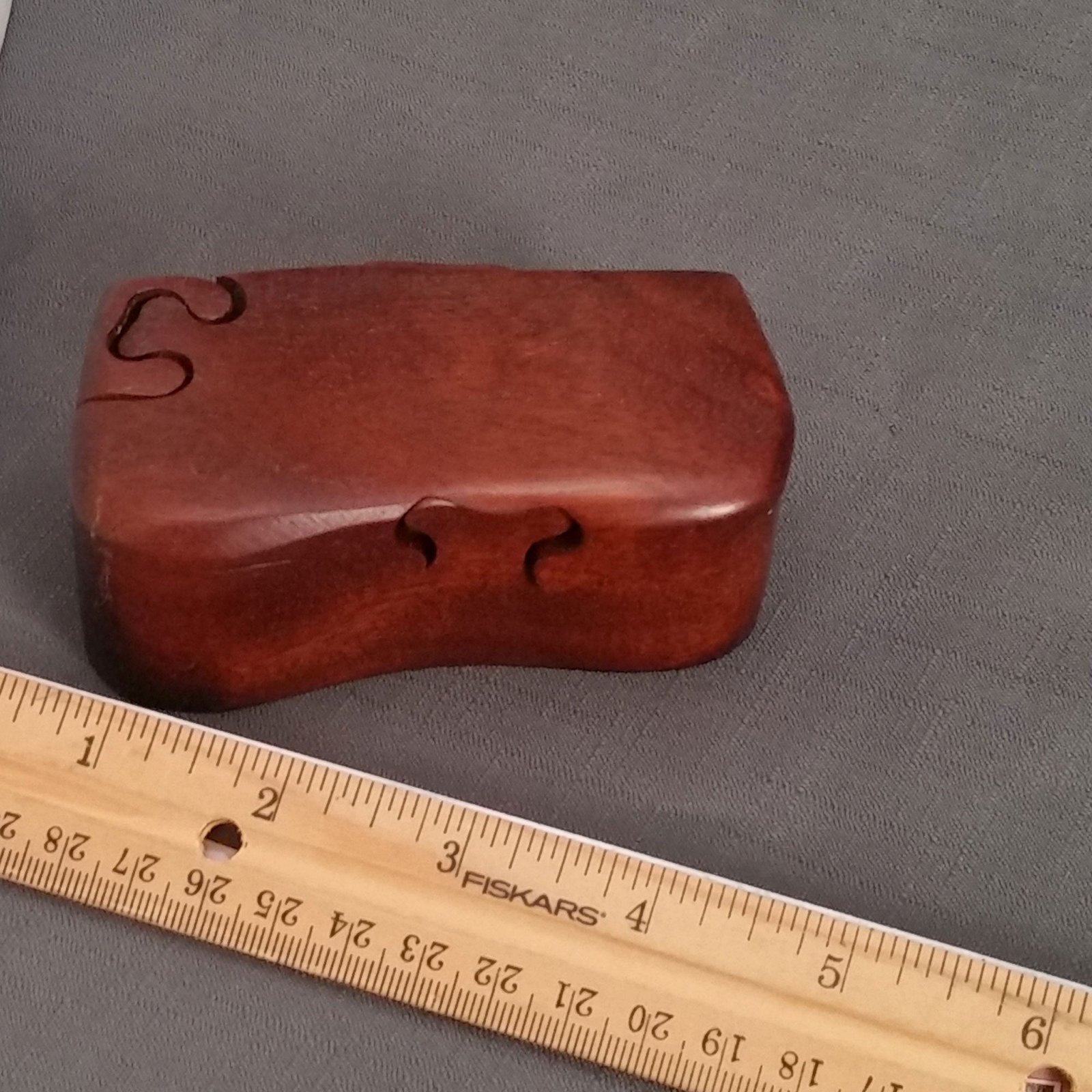 Mahogany bandsawn puzzle box with a ruler for scale, by Designs by Baerreis