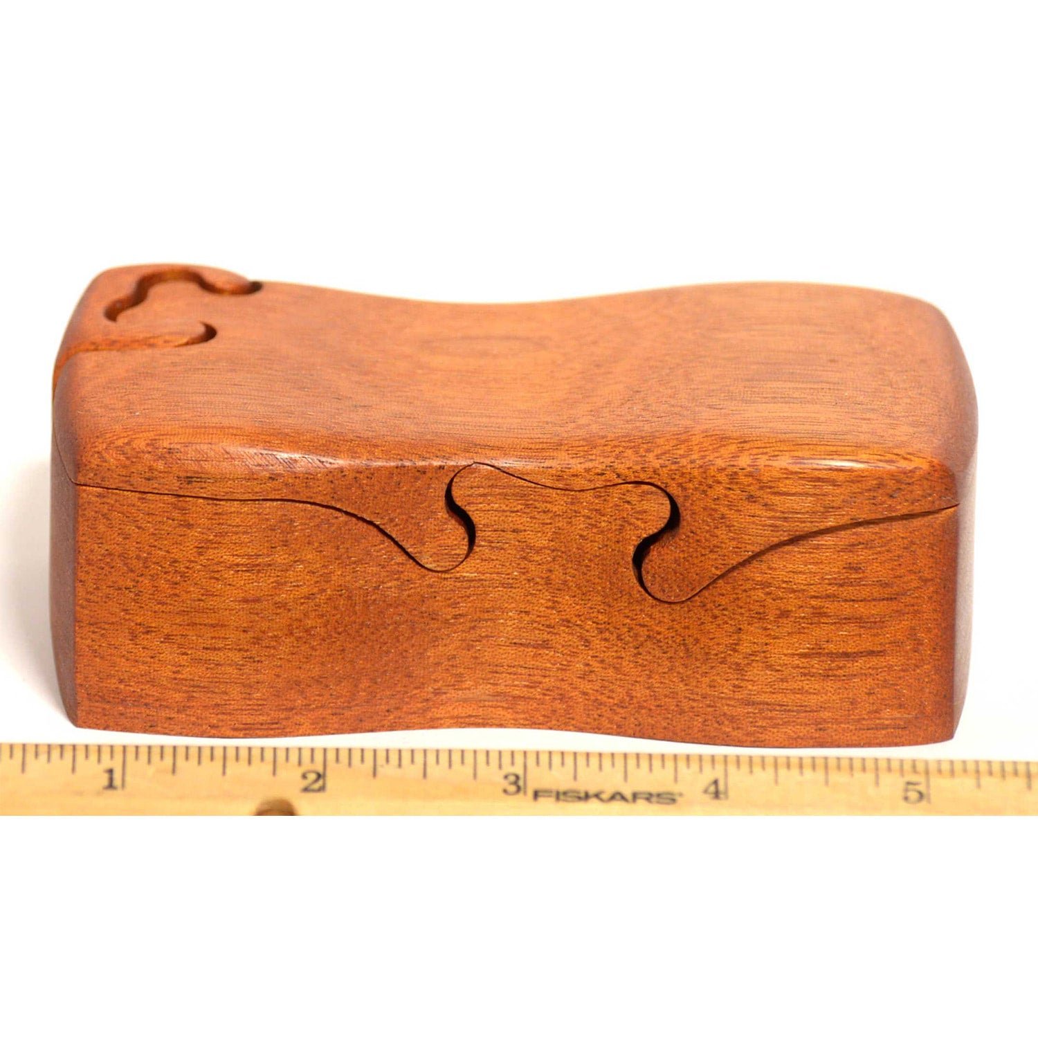 Mahogany bandsawn puzzle box with a ruler for scale, by Designs by Baerreis