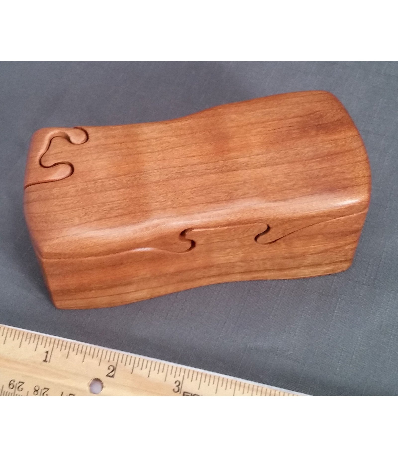 Natural cherry bandsawn puzzle box with a ruler for scale, by Designs by Baerreis